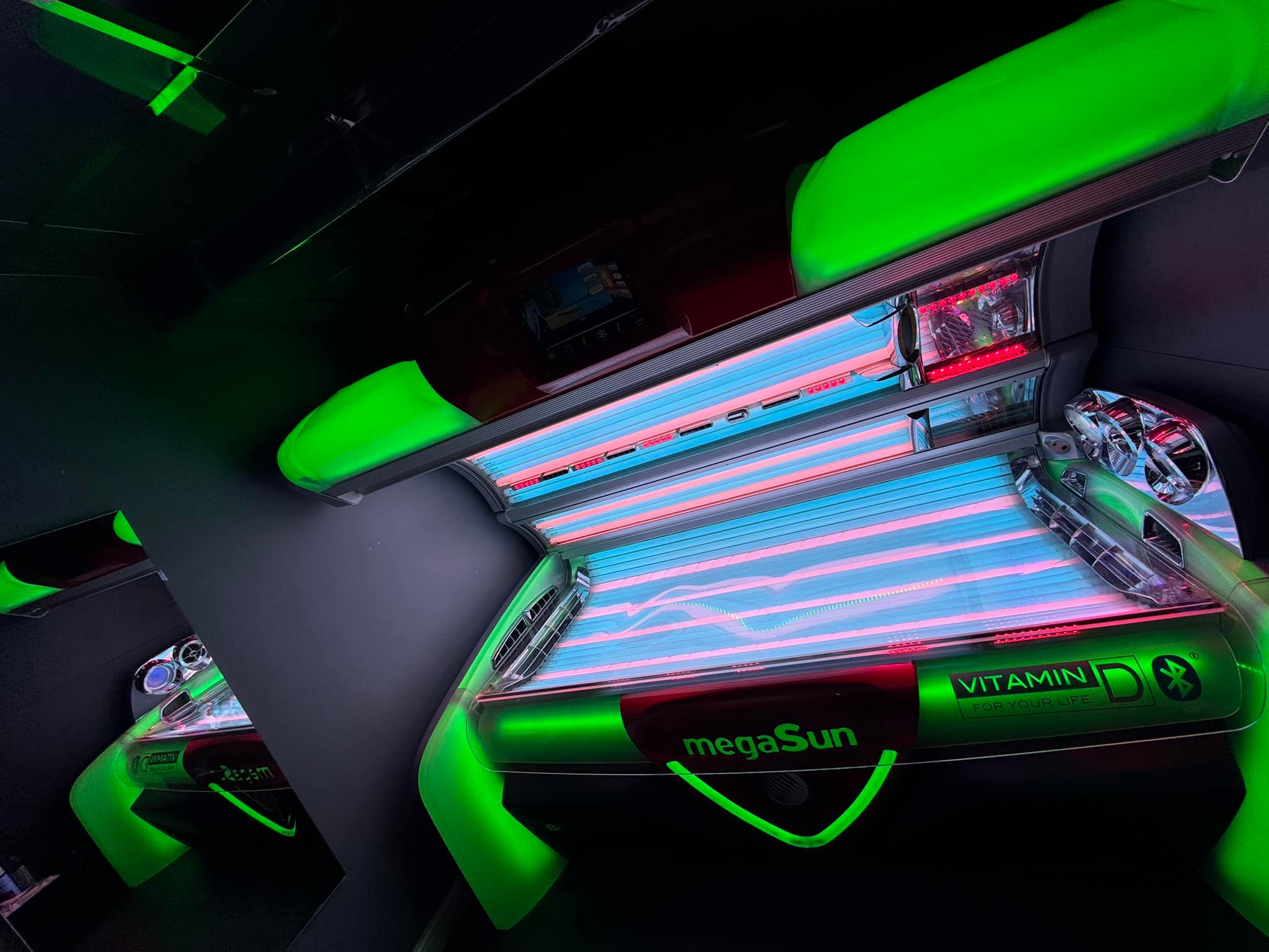 The megaSun 8000 alpha Hybrid at Tantastic Tanning, canopy open, lit with green accent lighting